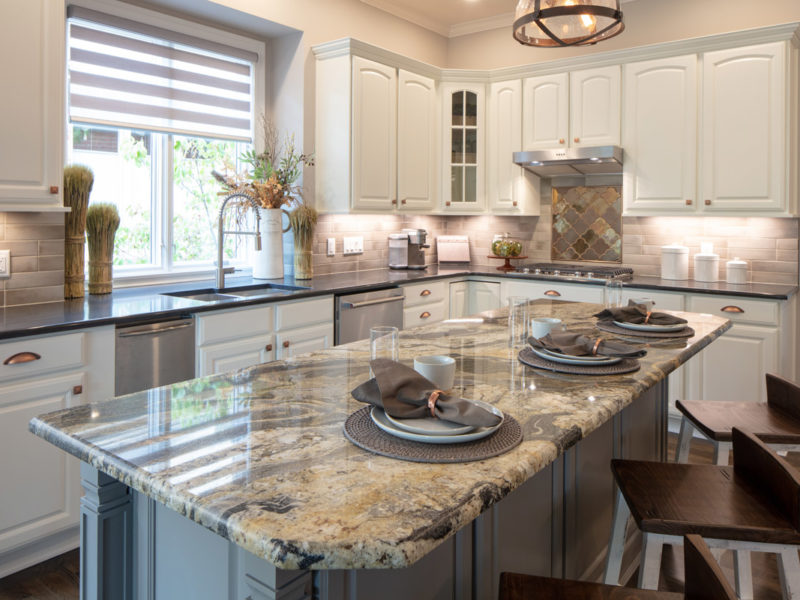 large island granite with gray and white cabinets